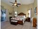 Spacious main bedroom with wooden furniture, patio access, and high ceilings at 47 Sportsman Ln, Rotonda West, FL 33947