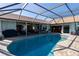 Inviting pool with screened enclosure and paved patio area at 47 Sportsman Ln, Rotonda West, FL 33947