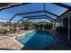 Private pool with screened enclosure, hot tub, and ample space for lounging at 47 Sportsman Ln, Rotonda West, FL 33947
