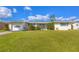 Ranch-style home with carport and spacious lawn at 521 Shamrock Blvd, Venice, FL 34293