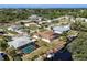 Waterfront home featuring a private boat dock, screened-in lanai, and a pool in a tropical neighborhood at 560 Sandlor Dr, Englewood, FL 34223
