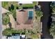 An overhead shot of a home with a private pool, boat dock, screened-in lanai, and landscaped backyard on the water at 560 Sandlor Dr, Englewood, FL 34223