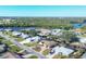 Elevated perspective of the property and its surrounding waterfront area at 560 Sandlor Dr, Englewood, FL 34223