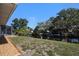 Scenic backyard view of the canal with lush greenery, providing a serene and private outdoor space at 560 Sandlor Dr, Englewood, FL 34223