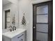 Updated bathroom featuring a gray vanity with a white sink and modern black faucet at 560 Sandlor Dr, Englewood, FL 34223