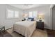 Well-lit bedroom with plantation shutters, wooden floors, and a comfy bed with blue accents at 560 Sandlor Dr, Englewood, FL 34223
