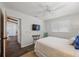 Comfortable bedroom with a mounted TV, closet access, and natural light from the shuttered window at 560 Sandlor Dr, Englewood, FL 34223