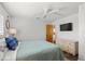 Bright bedroom featuring a ceiling fan, shuttered windows, and a woven dresser at 560 Sandlor Dr, Englewood, FL 34223