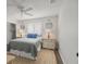 Bedroom with coastal decor, wood floors, and plenty of natural light from the shuttered windows at 560 Sandlor Dr, Englewood, FL 34223