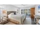 Bedroom featuring plantation shutters, a woven headboard, and a door leading to the pool area at 560 Sandlor Dr, Englewood, FL 34223