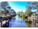 Picturesque canal view lined with lush greenery and other homes at 560 Sandlor Dr, Englewood, FL 34223