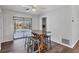 Casual dining area with a table and bar stools, overlooking the backyard pool at 560 Sandlor Dr, Englewood, FL 34223