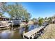 Private dock with boat lift extending into a tranquil canal at 560 Sandlor Dr, Englewood, FL 34223