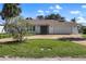 Traditional single-story home featuring a two-car garage and a well-maintained lawn at 560 Sandlor Dr, Englewood, FL 34223