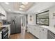 Modern kitchen features stainless steel appliances, granite countertops, and bright lighting at 560 Sandlor Dr, Englewood, FL 34223