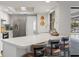 Bright kitchen with a breakfast bar and stainless steel appliances next to the pool at 560 Sandlor Dr, Englewood, FL 34223