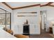 Kitchen with white cabinetry and wooden accents. Includes bar seating and beverage fridge at 560 Sandlor Dr, Englewood, FL 34223