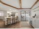 Kitchen bar seating with a view of the outdoor pool through large sliding glass doors at 560 Sandlor Dr, Englewood, FL 34223