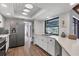 Bright, updated kitchen with stainless steel appliances, white cabinets, and ample counter space at 560 Sandlor Dr, Englewood, FL 34223