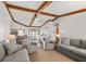 Spacious living area featuring exposed wood beams and comfortable seating arrangements at 560 Sandlor Dr, Englewood, FL 34223