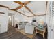 Spacious living room with exposed beams, neutral colors, and hardwood floors at 560 Sandlor Dr, Englewood, FL 34223