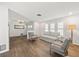 Bright living room featuring hardwood floors, neutral paint, and an abundance of natural light at 560 Sandlor Dr, Englewood, FL 34223