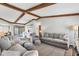 Inviting living room with exposed beams, plush seating, and a view to the backyard at 560 Sandlor Dr, Englewood, FL 34223