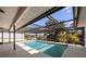 Beautiful screened-in pool offers a private oasis with views of lush greenery at 560 Sandlor Dr, Englewood, FL 34223