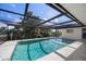 Screened-in swimming pool with clear blue water, perfect for relaxation and entertainment at 560 Sandlor Dr, Englewood, FL 34223