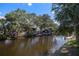 Scenic waterfront canal view with lush landscaping, private boat docks and direct water access at 560 Sandlor Dr, Englewood, FL 34223