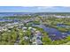 An aerial view of the neighborhood with waterways, docks, and bridges at 7064 Baypine Ln, Englewood, FL 34224