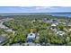 Birds-eye view of the home's location, including a view of the backyard pool and surrounding trees at 7064 Baypine Ln, Englewood, FL 34224