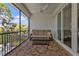 Screened-in balcony with seating and outdoor views at 7064 Baypine Ln, Englewood, FL 34224