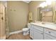 Modern bathroom featuring white vanity, light countertops, and a walk-in shower at 7064 Baypine Ln, Englewood, FL 34224