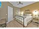 Inviting bedroom with a king-size bed, wood-paneled wall, and coastal decor at 7064 Baypine Ln, Englewood, FL 34224
