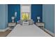 Tranquil bedroom featuring a calming blue wall, plush bed, and beachy accents at 7064 Baypine Ln, Englewood, FL 34224