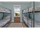 Spacious bunk room with metal bunk beds, ideal for accommodating multiple guests at 7064 Baypine Ln, Englewood, FL 34224