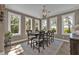 Dining area with large windows and seating for six at 7064 Baypine Ln, Englewood, FL 34224