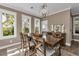 Dining room with a table, chairs, and natural light from windows at 7064 Baypine Ln, Englewood, FL 34224