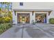 Garage with storage, bikes, and partially open doors at 7064 Baypine Ln, Englewood, FL 34224