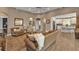 Inviting living room with wicker furniture, a ceiling fan, and open access to the kitchen at 7064 Baypine Ln, Englewood, FL 34224