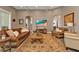 Living room with comfortable furniture, area rug, and a flat-screen TV at 7064 Baypine Ln, Englewood, FL 34224