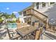 Patio dining area by the pool with stairs to the deck at 7064 Baypine Ln, Englewood, FL 34224