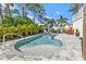 Private pool with surrounding patio and tropical landscaping at 7064 Baypine Ln, Englewood, FL 34224