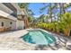 Backyard oasis featuring a pool, patio, and lush trees at 7064 Baypine Ln, Englewood, FL 34224