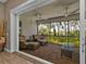 Relaxing screened porch with comfortable seating, ceiling fans, and serene views at 7064 Baypine Ln, Englewood, FL 34224
