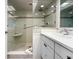 Bright bathroom with a glass shower, white vanity, and tiled floor at 7478 Palm Island Dr # 2611, Placida, FL 33946