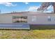 Home backyard features a large patio and sliding glass doors at 792 Lehigh Rd, Venice, FL 34293