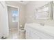 Bright bathroom featuring white cabinetry, tiled floors, and a shower with a curtain at 792 Lehigh Rd, Venice, FL 34293