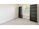 Cozy bedroom features neutral walls, carpet flooring, and a decorative bookshelf at 792 Lehigh Rd, Venice, FL 34293